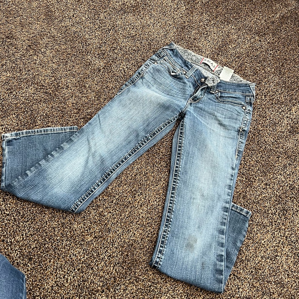 Ariat boot cut jeans. Size 28 short. Small stain on leg.